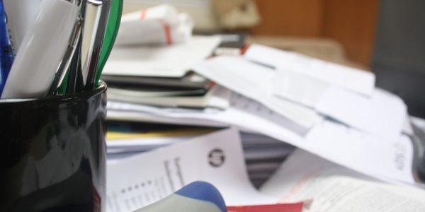 stack of accounting files on desk