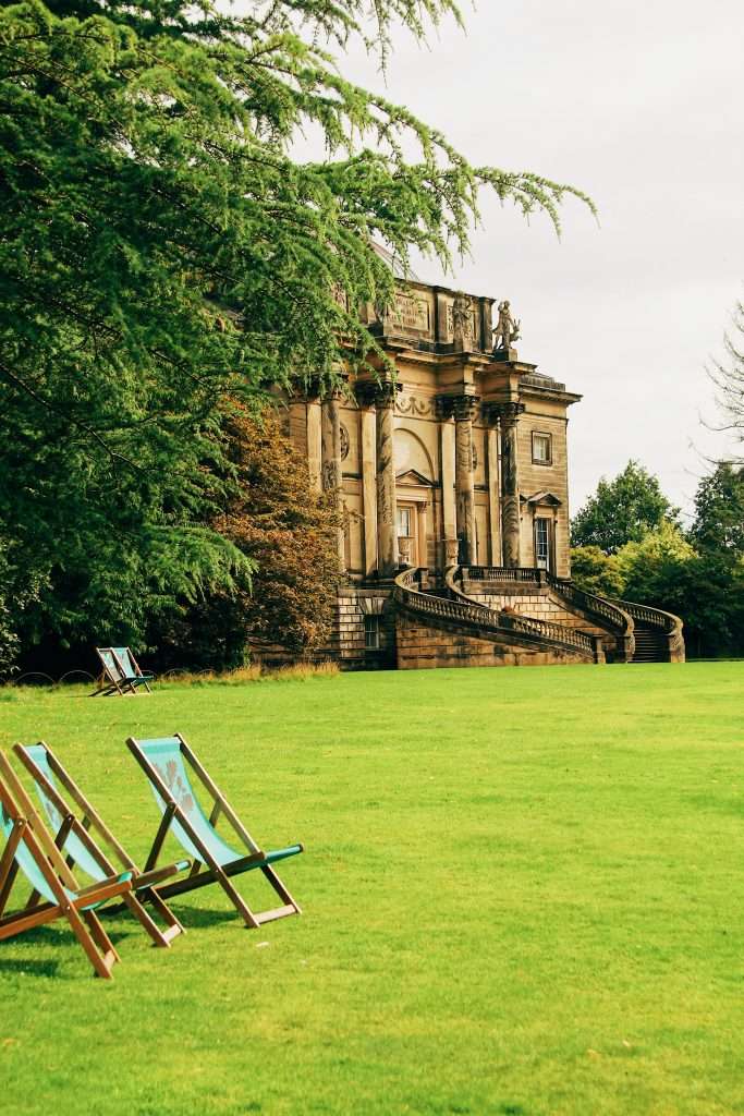 Business Support in Amber Valley - Kedleston Hall surrounded by trees with deckchairs in the foreground.