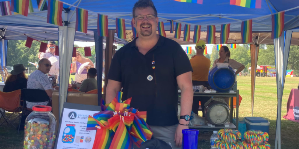 Kevin hosting a Pride stall. LGBTQ+ accountant