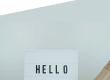 Photo of a person holding a sign saying 'HELLO' with the Ascentant logo