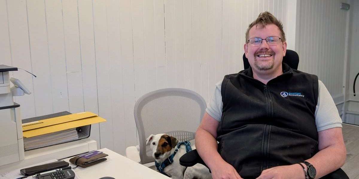 Alfie sat on his own chair next to Kevin at his desk.