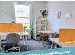 Picture of our hot desking room with Ascentant's logo and the testimonial on top.